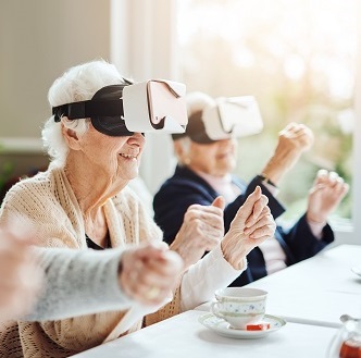 ladies in a care home with Virtual reality goggles on